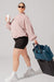 Model walking with travel bag and Ella Duffle - Deep Teal