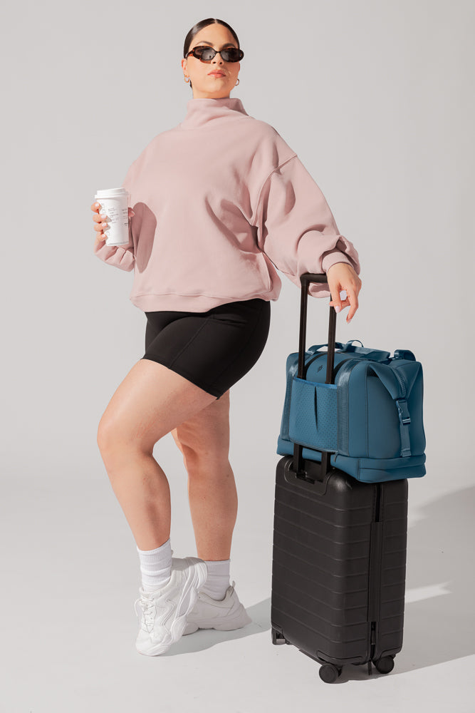 Model showing how the Ella Duffle - Deep Teal fit on your travel bag