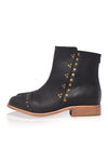 Black ankle boots with gold studs on a white background
