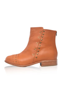 Tan ankle boot with gold studs on a white background