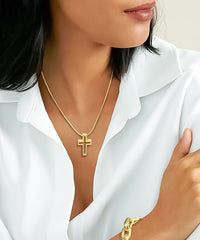 woman wearing B.Tiff Gold Lumière Cross Pendant