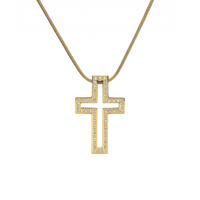A gold-colored cross pendant with a hollowed design, encircled by a frame set with small, round, clear stones, displayed against a white background.