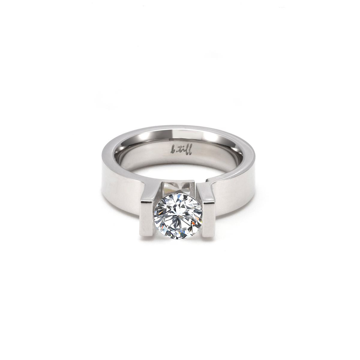 A view of  B.Tiff Tension 1 ct Moissanite Round Solitaire Engagement Ring laying flat