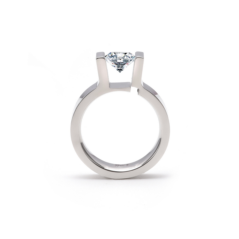 A round solitaire engagement ring with a 1 ct Moissanite stone in a tension setting, polish finish, and silver metal color.