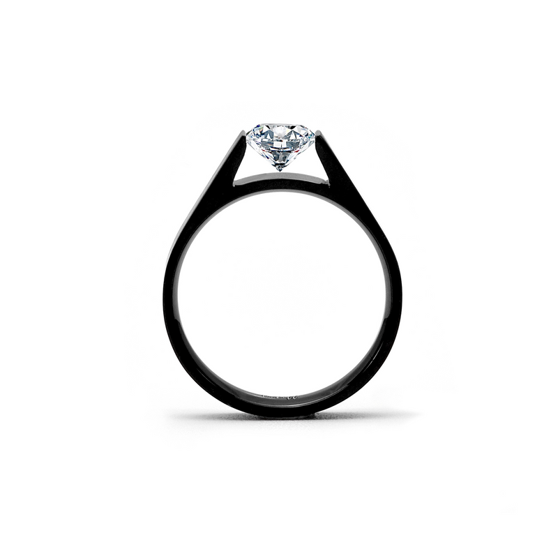 A black tension solitaire engagement ring with a round diamond at the top, set in a simple mounting.