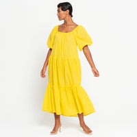 A Full view of a woman wearing ROSEMARY Dotted Cotton Dress, in Sunflower Yellow