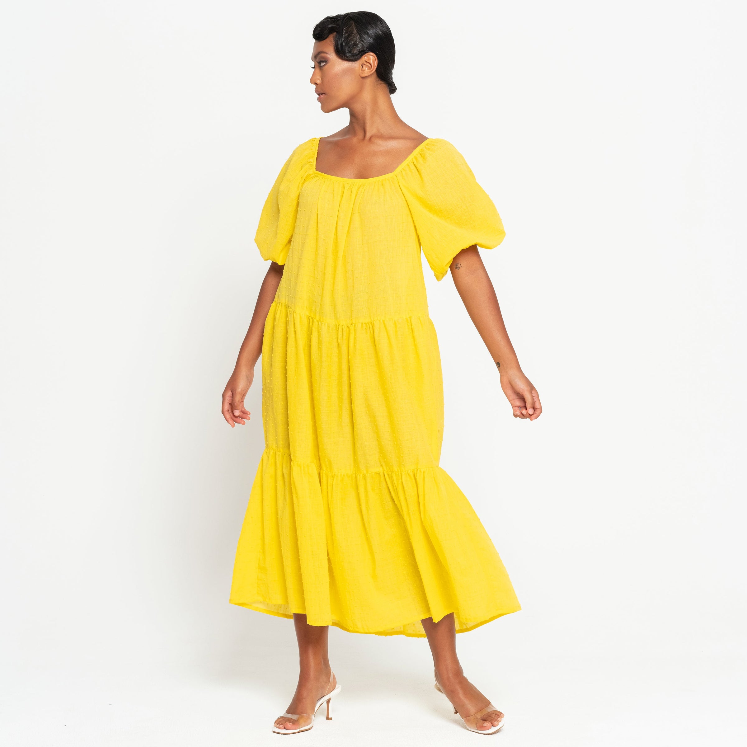 A Full view of a woman wearing ROSEMARY Dotted Cotton Dress, in Sunflower Yellow