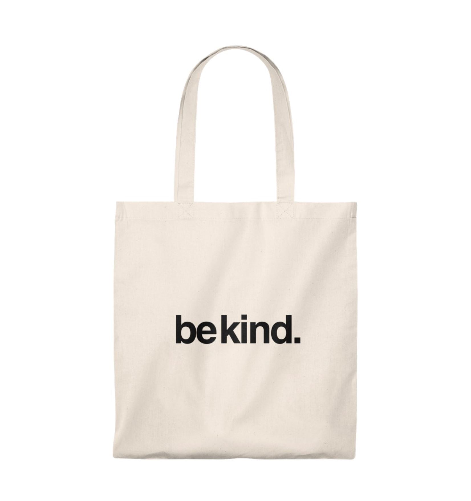 Beige tote bag with 'be kind.' text on a white background