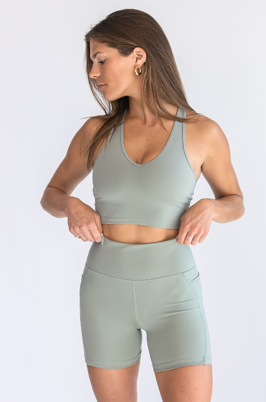A full body view of matching shorts V Neck Bra Top green