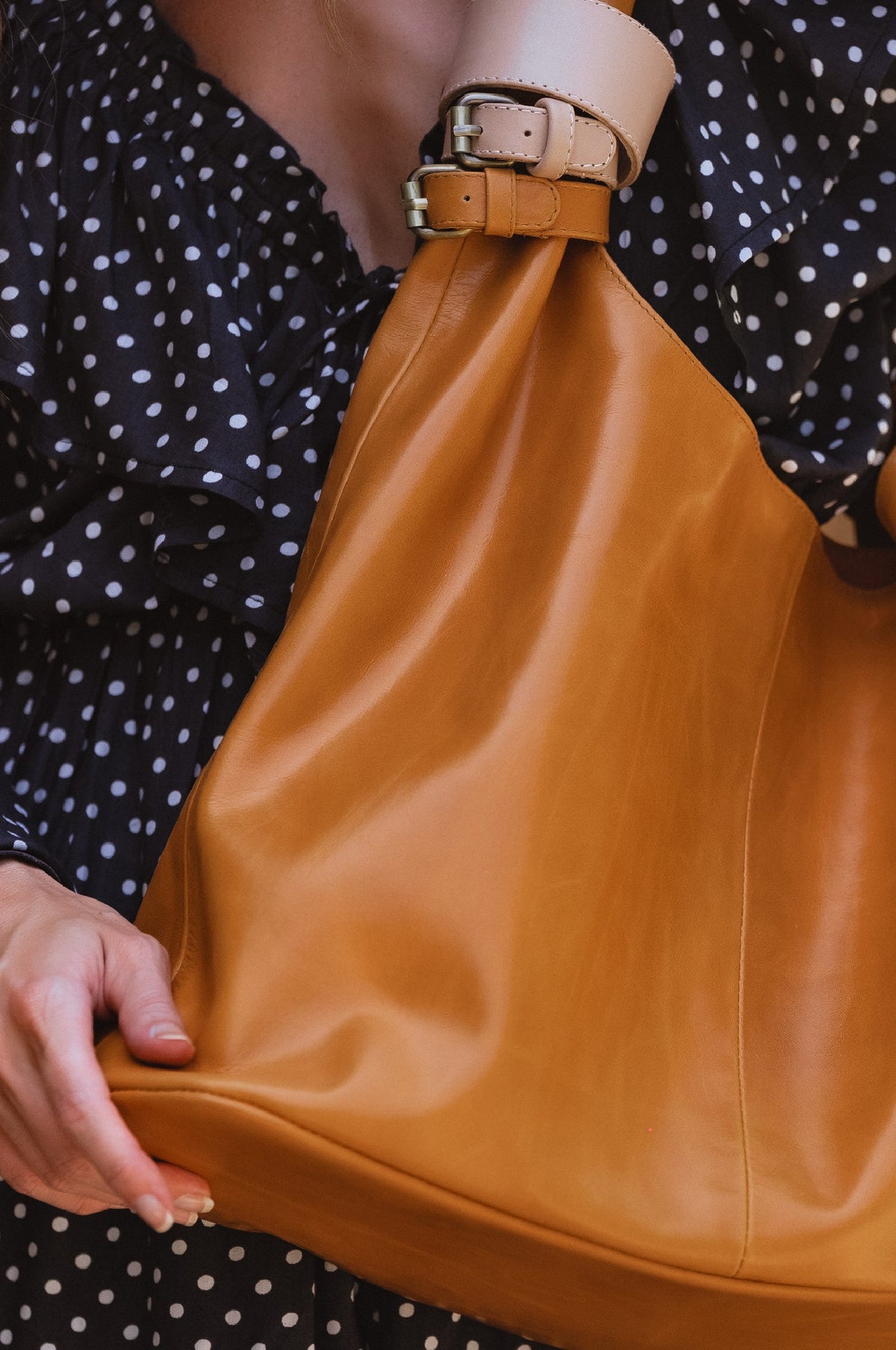 Model holding up Serendipity Slouchy Leather Tote Bag