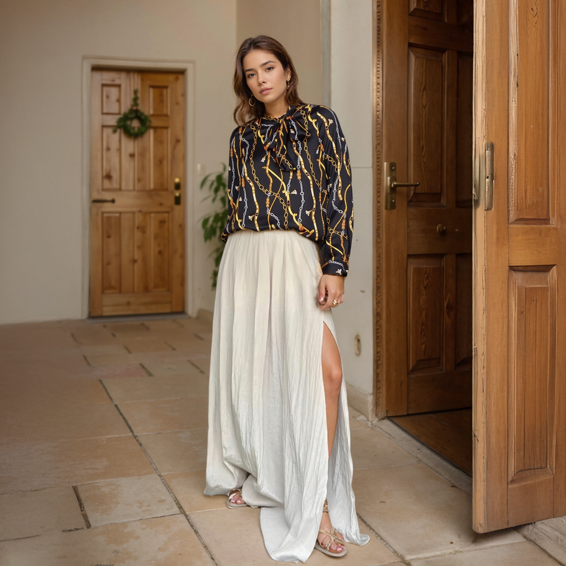 Woman in a patterned top and white skirt standing in a doorway.