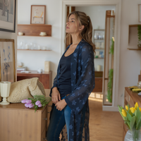 Woman standing in a room with flowers and decor