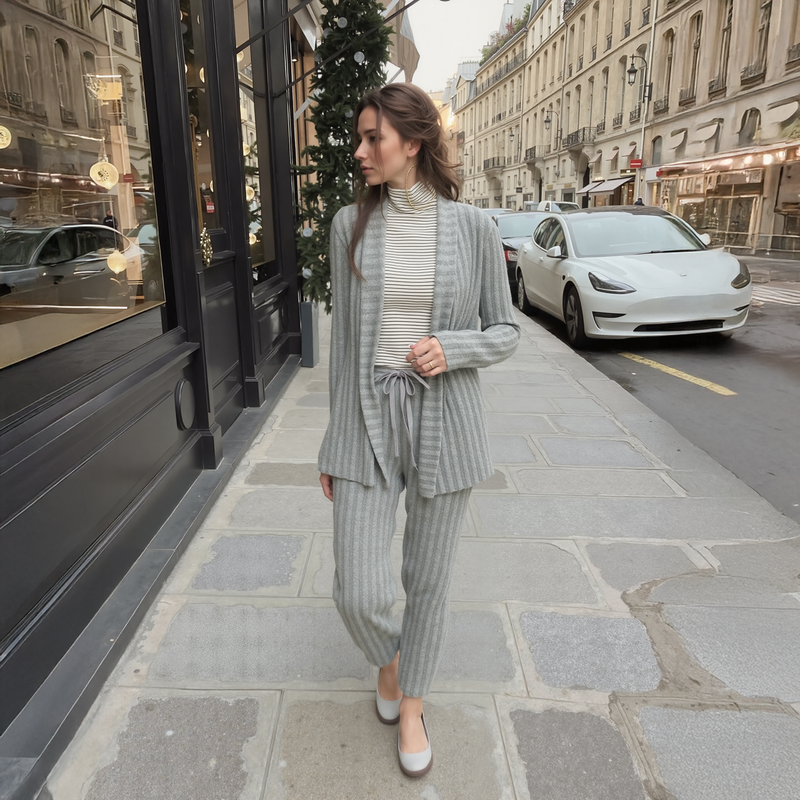 Woman in a gray suit walking on a city street