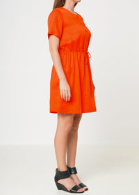 Model showing Left side of Women's Short Sleeve Utility Dress in Poppy