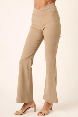 Beige pants worn by a person on a white background