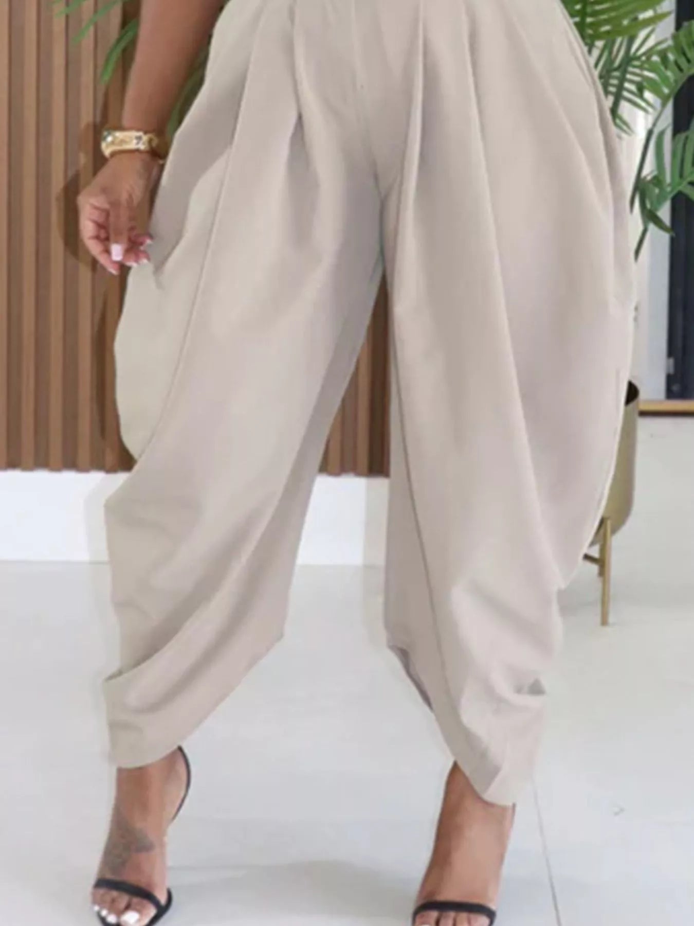 Beige wide-leg pants worn by a person indoors.