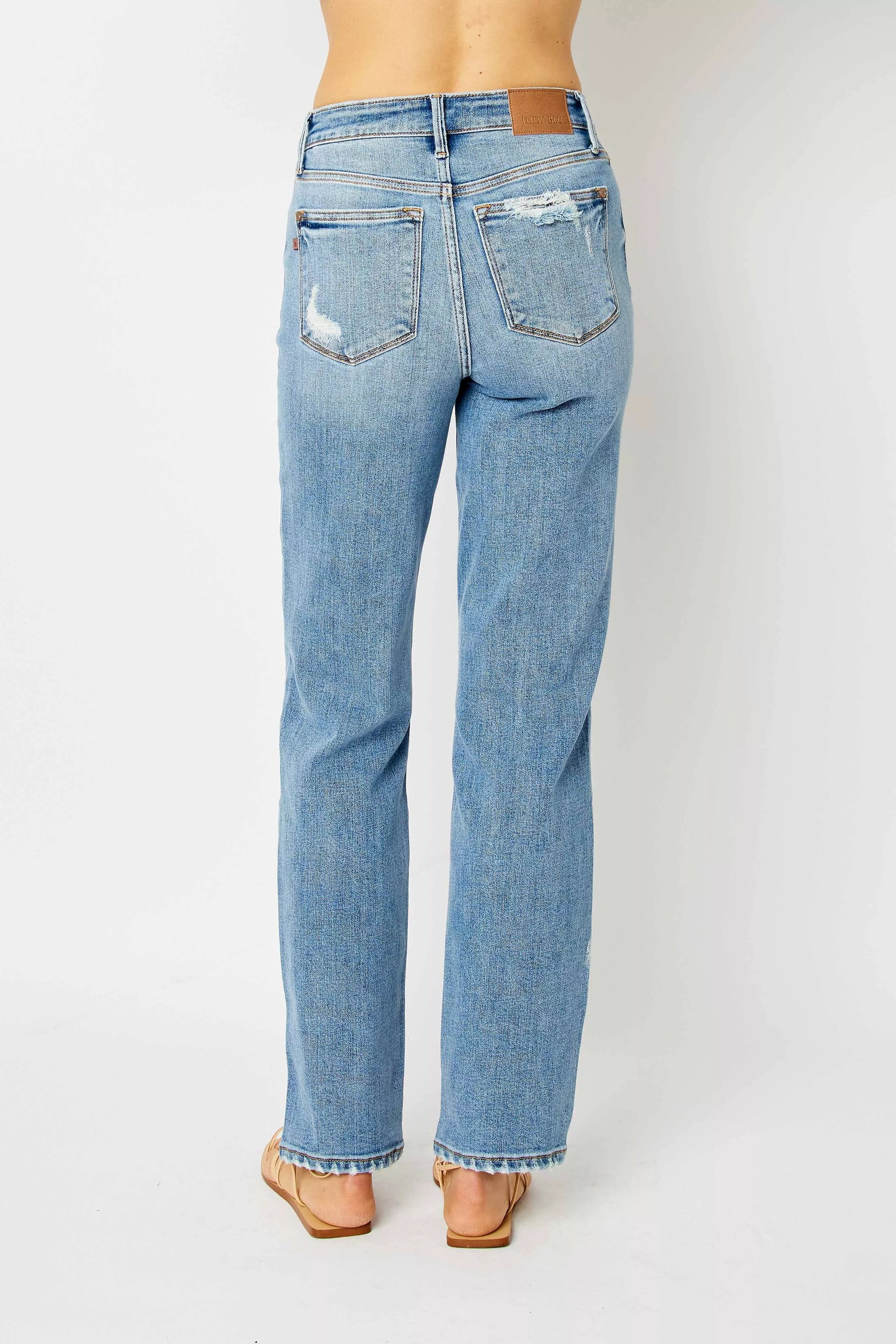 Light blue jeans worn by a person on a white background