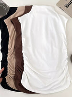 Three tank tops in black, beige, and white on a white background