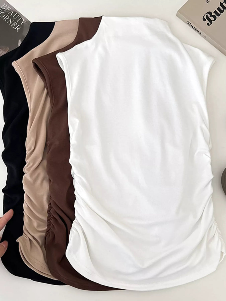 Three tank tops in black, beige, and white on a white background