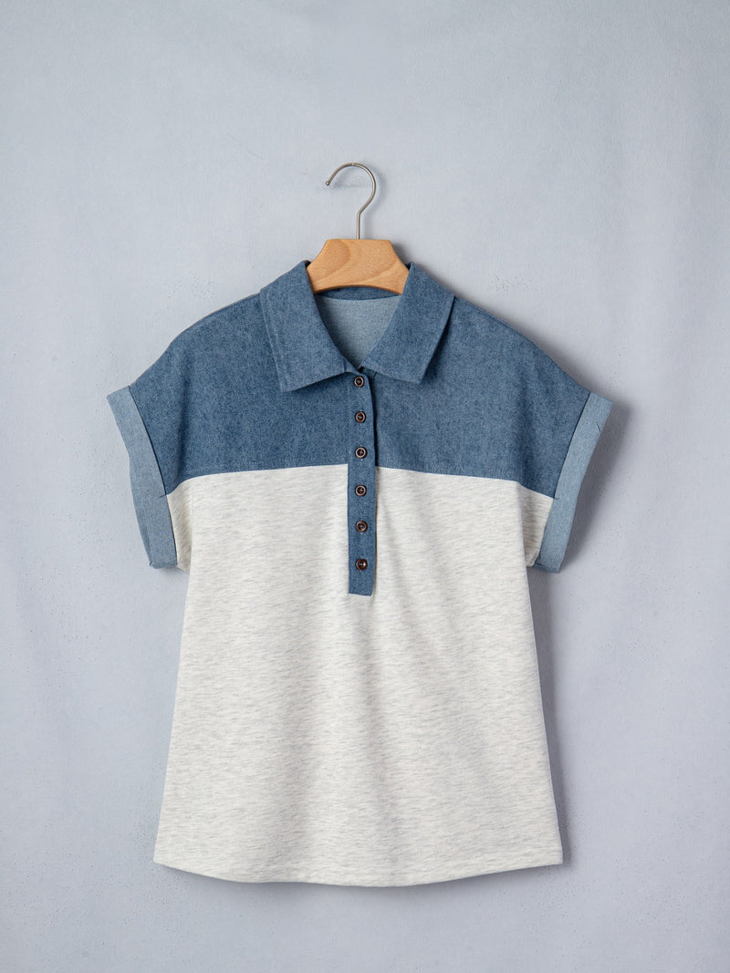 Two-tone blue and white shirt on a hanger against a gray background