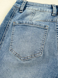 Close-up of a blue denim pocket on jeans.