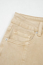 Close-up of beige pants with a pocket on a light gray background