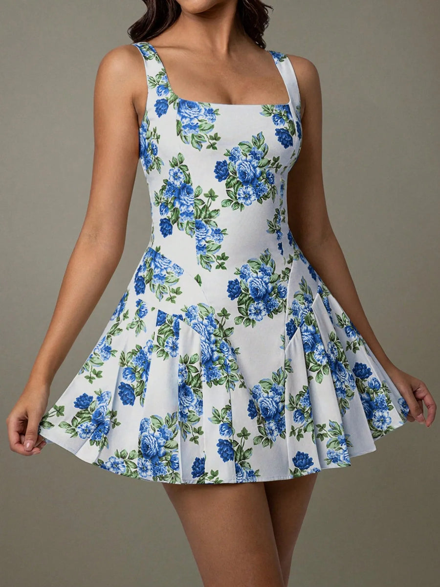 Woman wearing a floral dress with blue flowers on a plain background