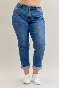 Blue jeans worn by a person on a plain background