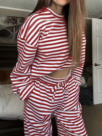 Person wearing a red and white striped outfit in a room.