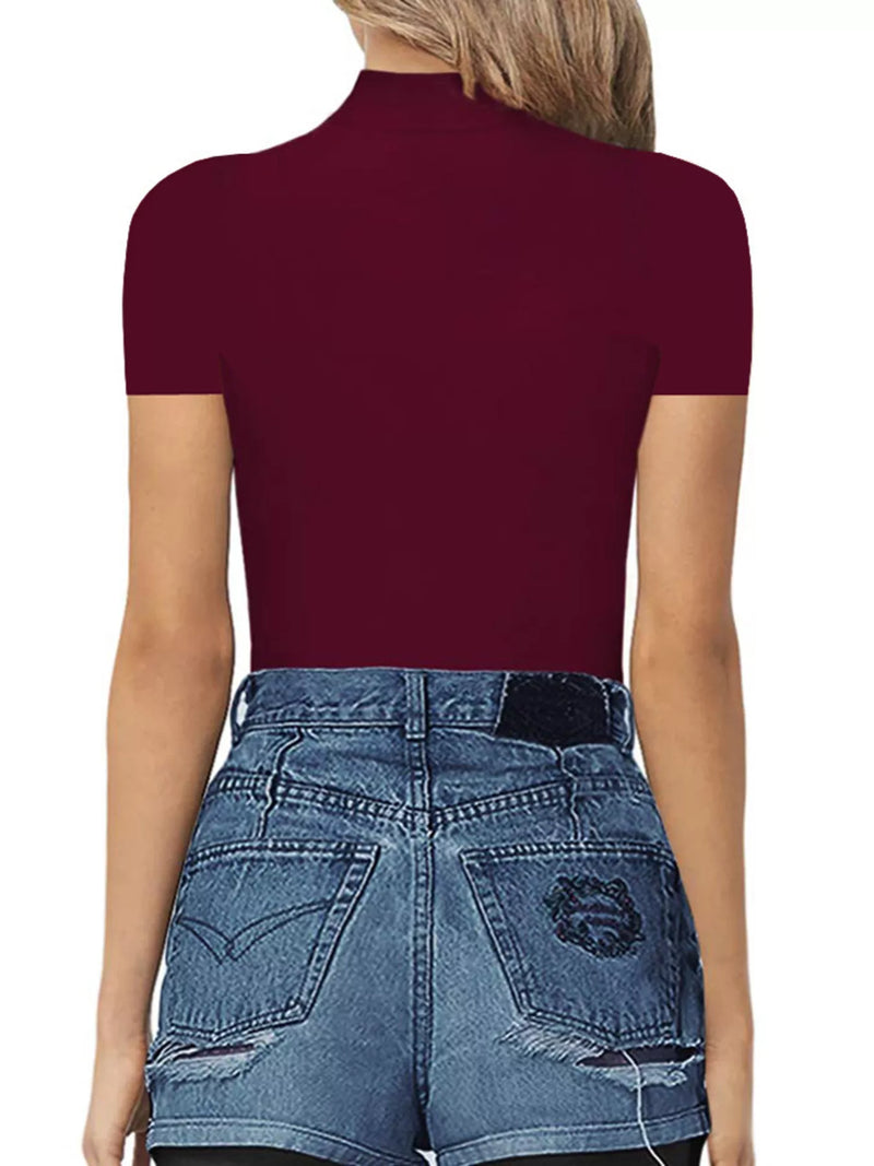 Person wearing a maroon short-sleeve top and blue jeans on a white background