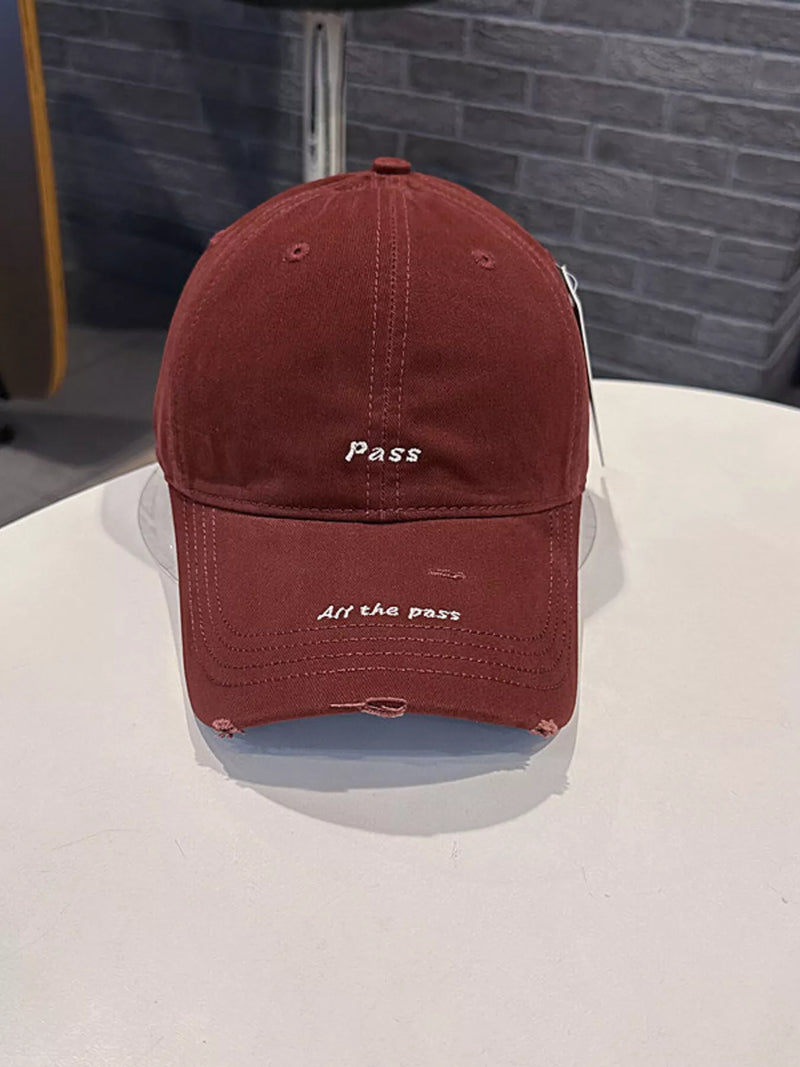 Red cap with text on a white surface and gray background