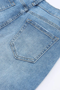 Close-up of a blue denim pocket on a white background