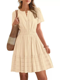 Beige dress worn by a person on a white background