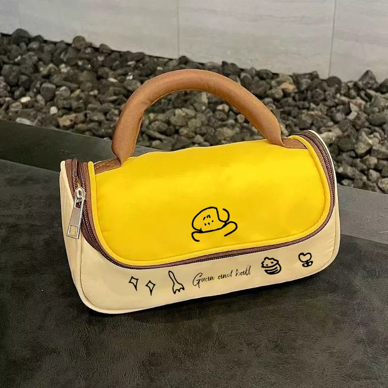 Yellow and beige bag with cartoon character and text on a dark surface