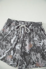 Floral patterned shorts with drawstring on a white background