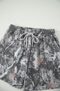 Floral patterned shorts with drawstring on a white background