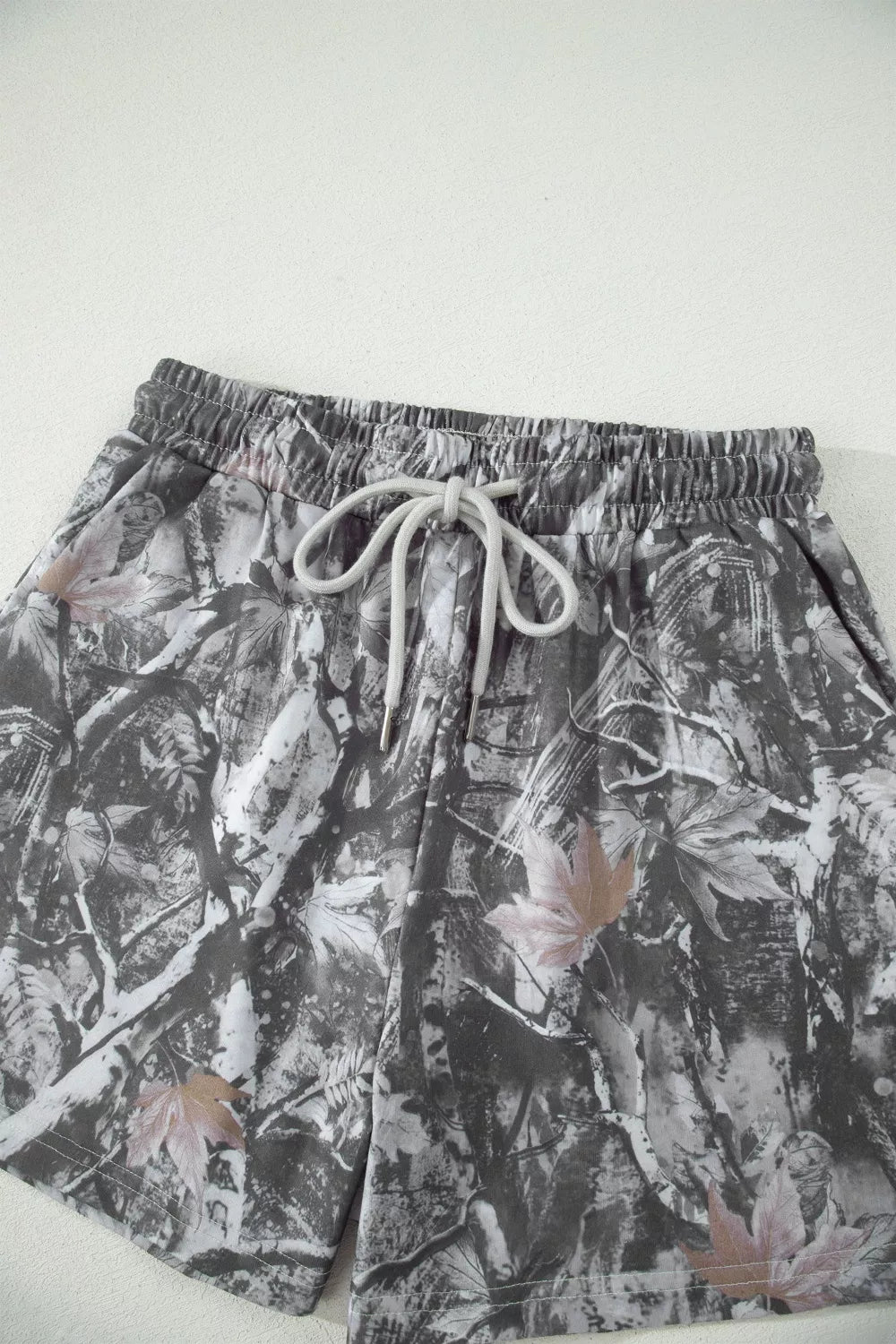 Floral patterned shorts with drawstring on a white background