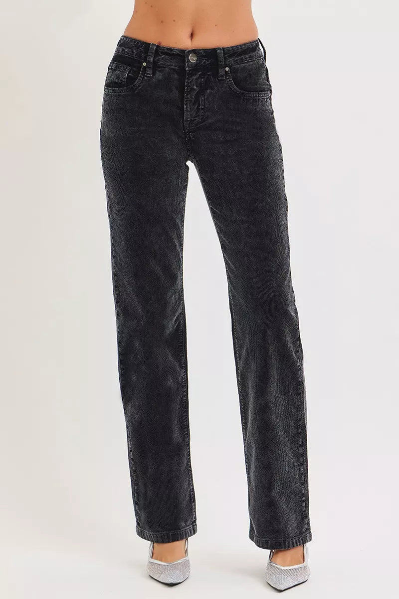 Black jeans worn by a person on a white background