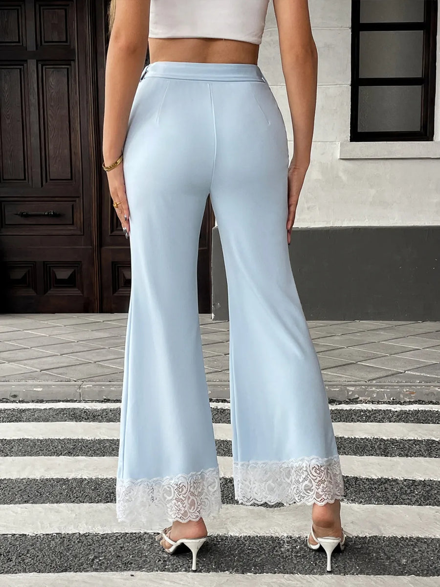 Light blue pants with lace trim worn by a person on a street.