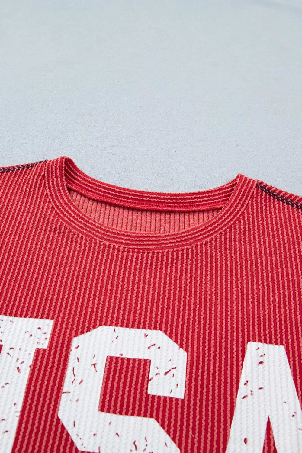 Red shirt with white text on a light gray background