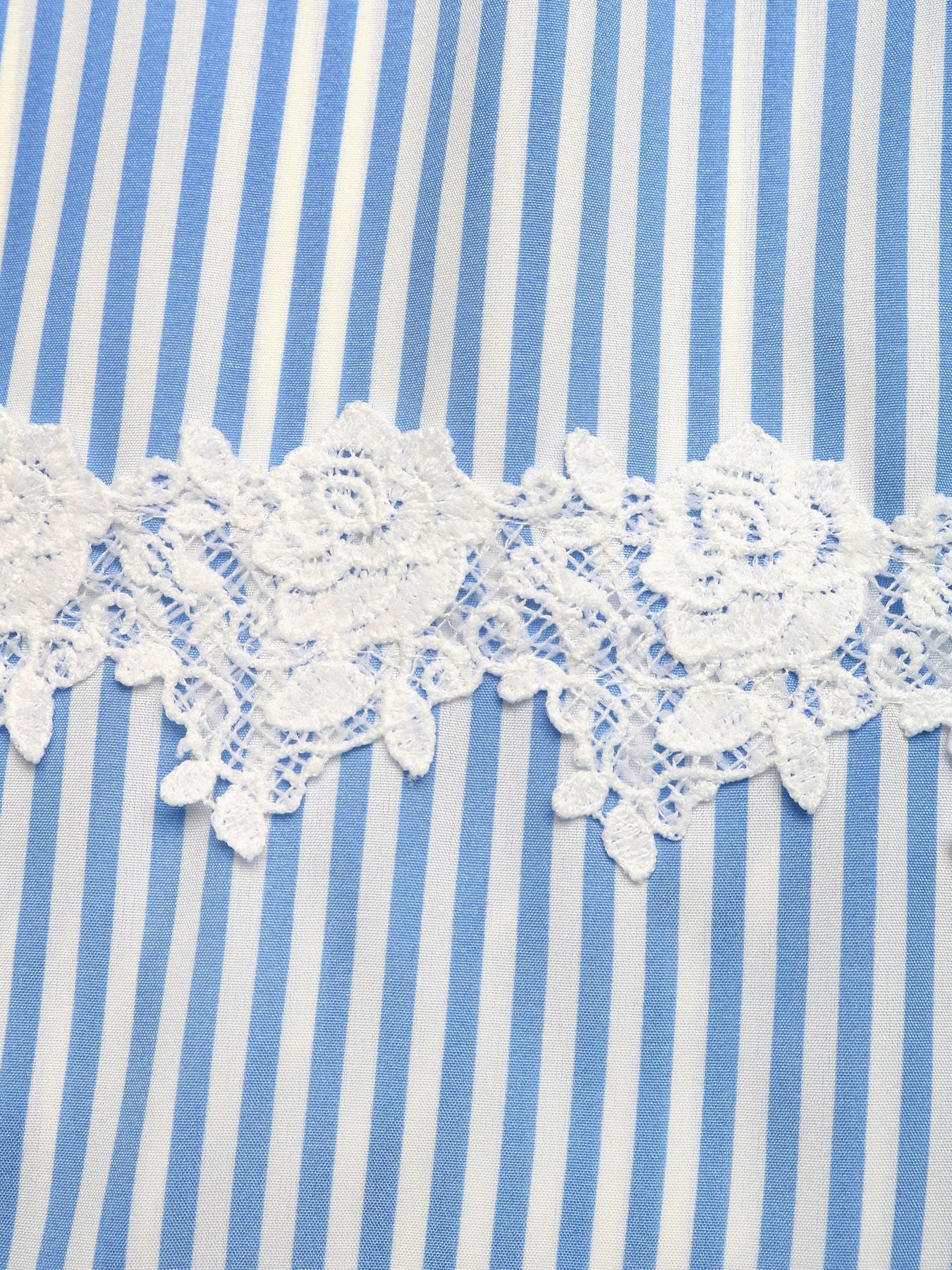 Close-up of blue and white striped fabric with lace trim
