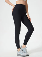 Person wearing black leggings on a white background