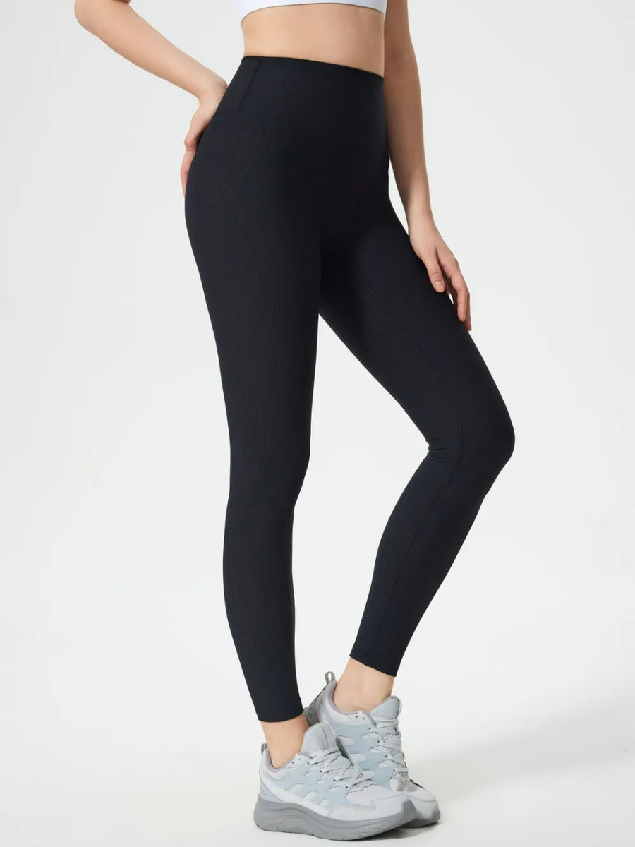 Person wearing black leggings on a white background