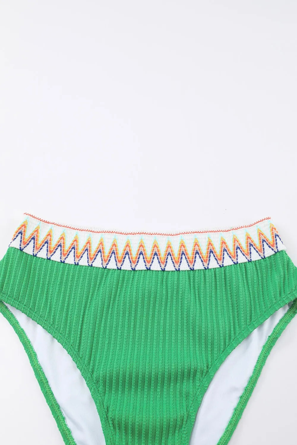 Green bikini bottom with colorful waistband on a white background