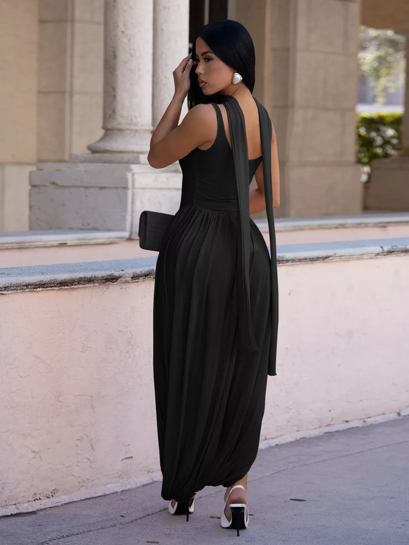Woman in a black dress standing in front of classical architecture