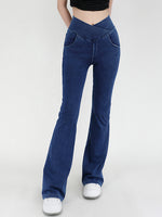 Blue flared pants worn by a person on a white background