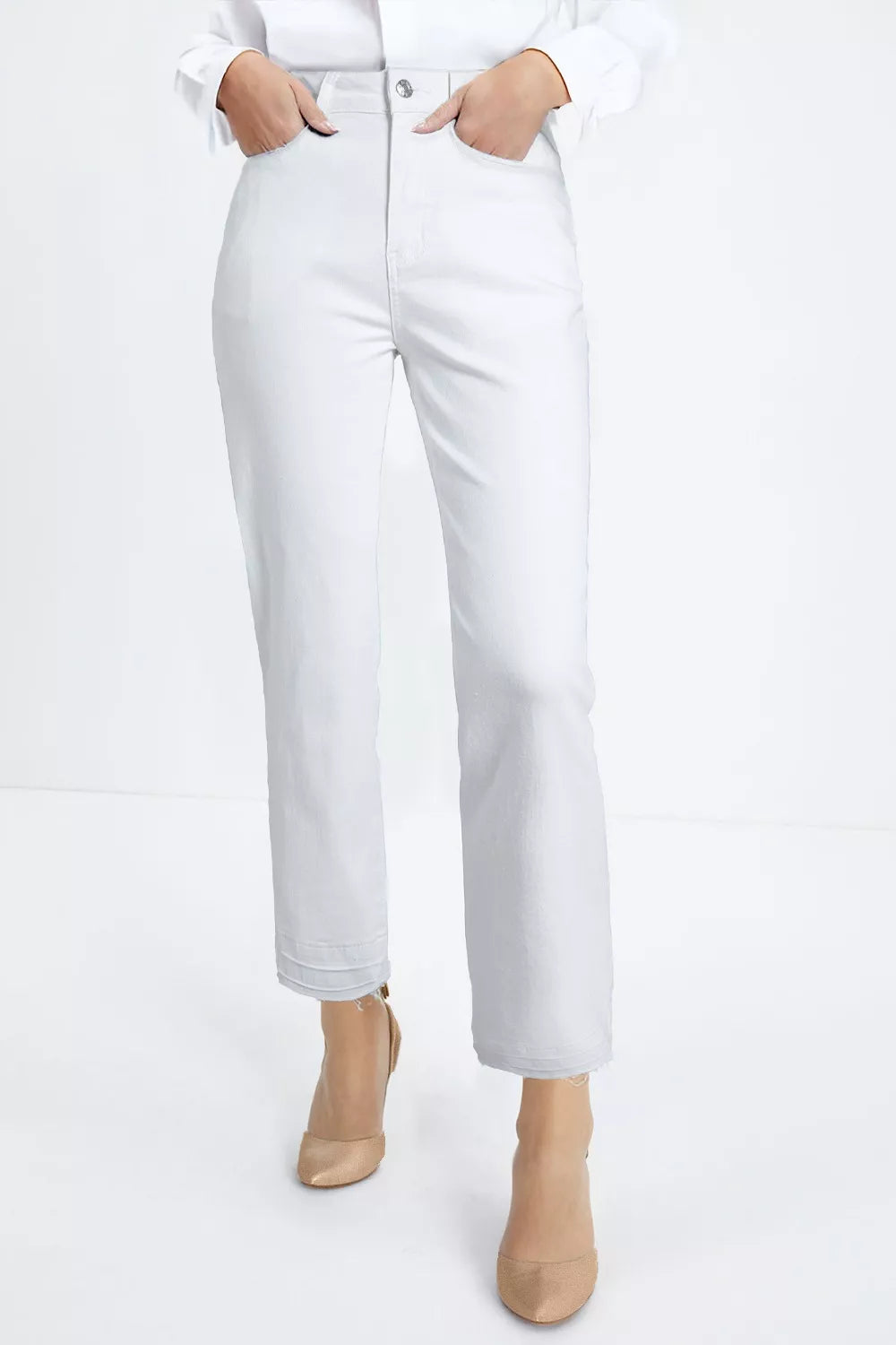 Person wearing white jeans and beige boots on a white background