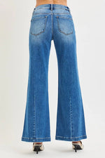 Blue jeans being worn on a white background
