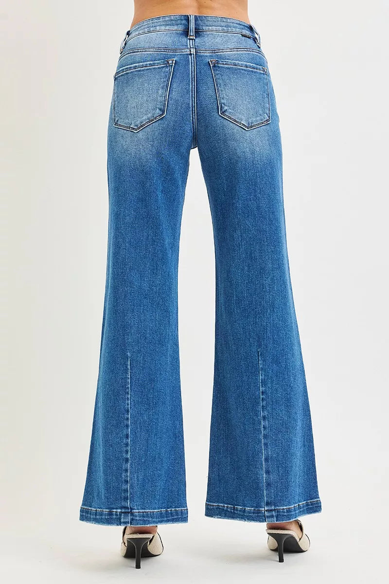 Blue jeans being worn on a white background