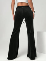 Black wide-leg pants worn by a person on a white background